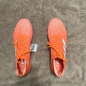 Soccer cleats, coral colored, brand: Adidas size: 9 woman’s shoes.